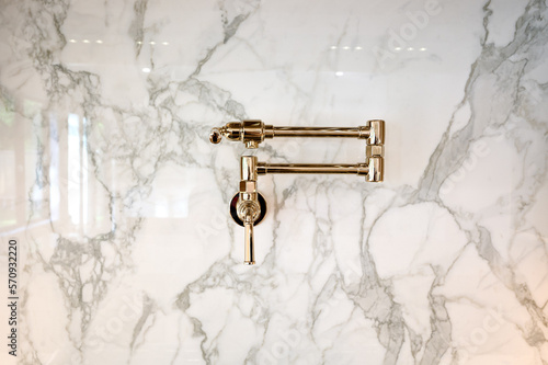 Pot Filler on natural stone wall in kitchen