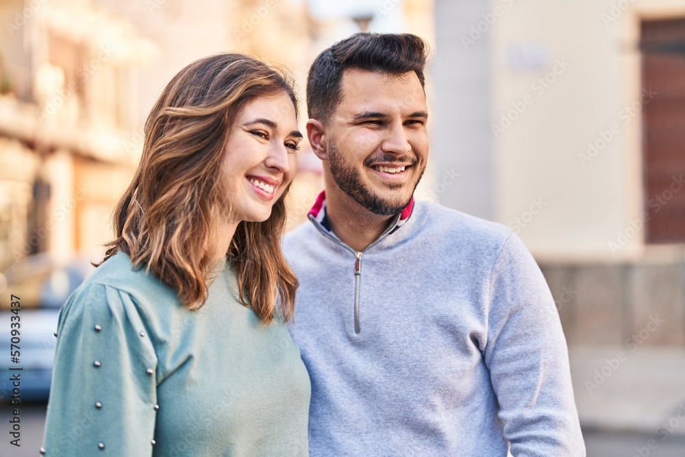 Man and woman smiling confident standing together at street