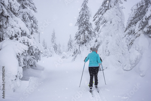 Woman skiing in frozen forest