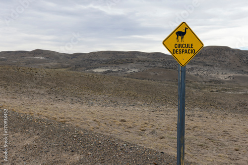 Yellow sign with a guanaco and "drive slowly" written on it in the beautiful Parque Patagonia in Argentina, South America