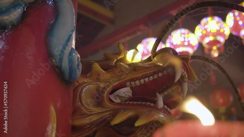 Mythical dragon head carving in a Buddhist temple photo