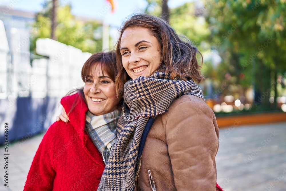 Two women mother and daughter hugging each other at park Two women mother and daughter hugging each other at park