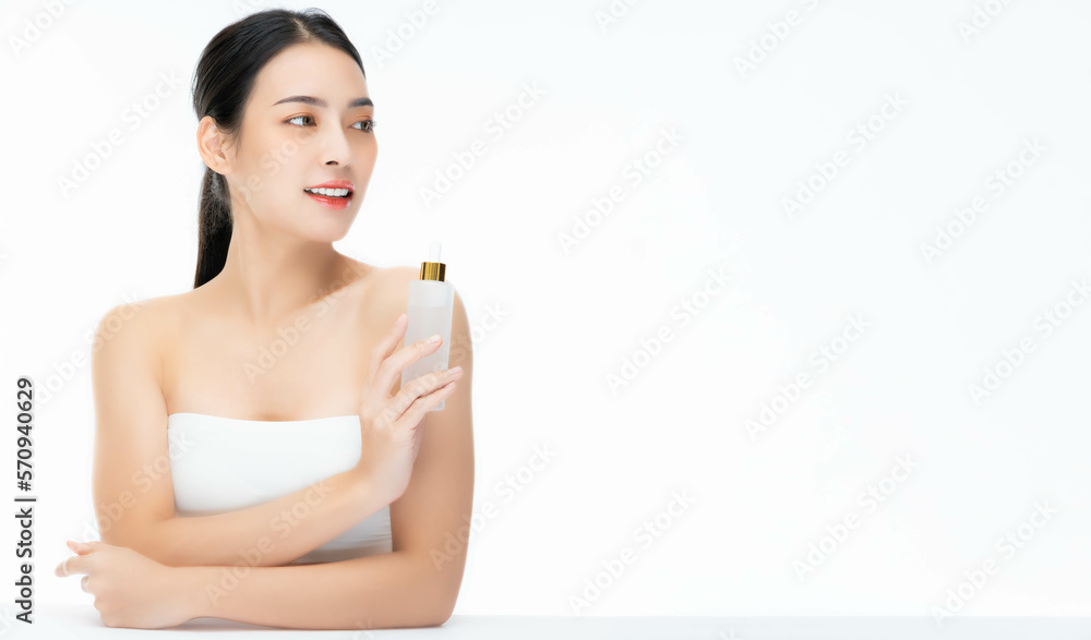 Beauty asian woman hold face serum cosmetic bottle look beside Beautiful Asian female showing skincare bottle product Beauty face body portrait isolated on white background copy space Present product Beauty asian woman hold face serum cosmetic bottle look beside Beautiful Asian female showing skincare bottle product Beauty face body portrait isolated on white background copy space Present product