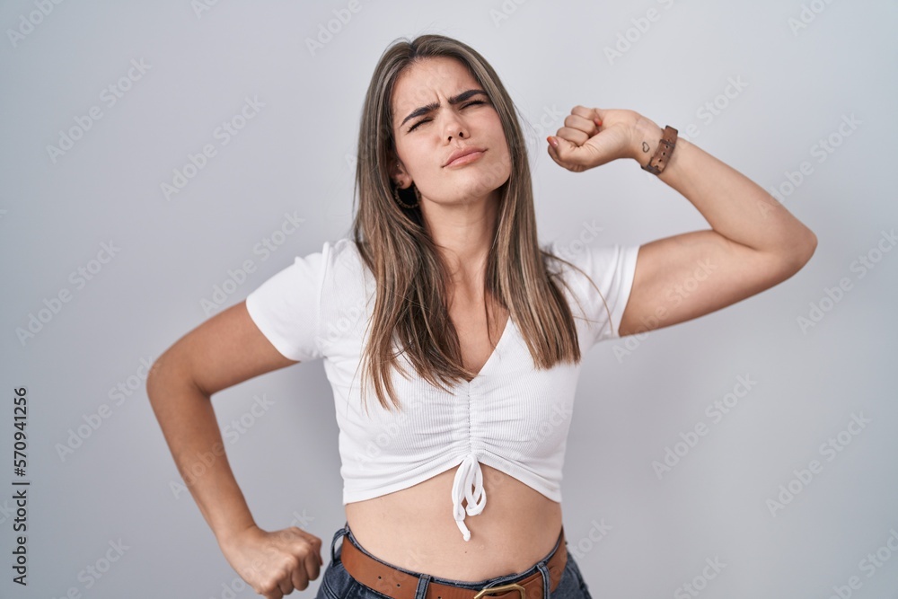 Young beautiful woman wearing casual white t shirt stretching back, tired and relaxed, sleepy and yawning for early morning Young beautiful woman wearing casual white t shirt stretching back, tired and relaxed, sleepy and yawning for early morning