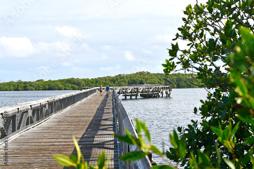 Long wooden boardwalk at John D. MacArthur Beach State Park in Palm Beach County, Florida.  photo