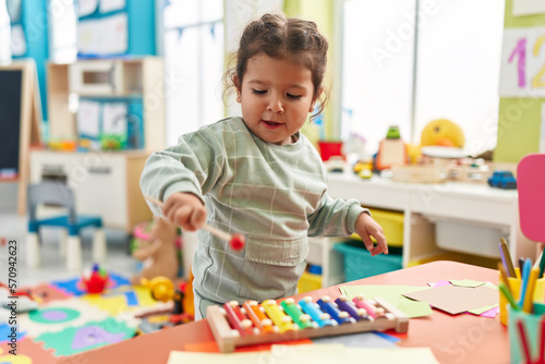 Tablou pe pânză Adorable hispanic toddler playing xylophone standing at kindergarten