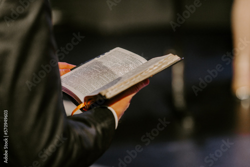 Fototapeta Pastor with a Bible in his hand during a sermon
