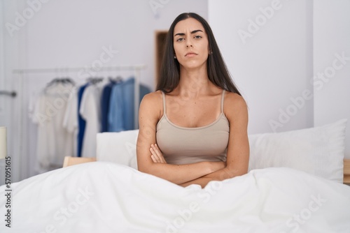 Young brunette woman in the bed at home skeptic and nervous, disapproving expression on face with crossed arms. negative person. © Krakenimages.com