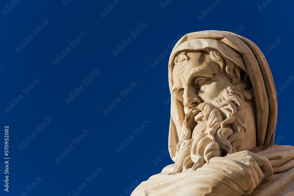 Old and wise man statue. A neoclassical marble statue erected in 1824  in Rome People's Square (with blue sky and copy space)