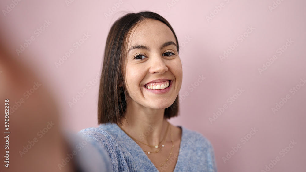 Young beautiful hispanic woman smiling confident make selfie by camera over isolated pink background Young beautiful hispanic woman smiling confident make selfie by camera over isolated pink background