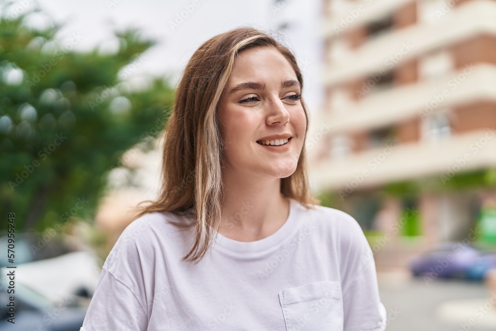Young woman smiling confident looking to the side at street Young woman smiling confident looking to the side at street