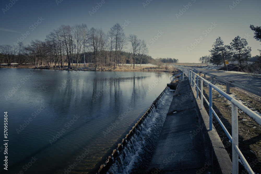 The end of winter, a small dam reservoir, a fishing ground in Poland. The end of winter, a small dam reservoir, a fishing ground in Poland.