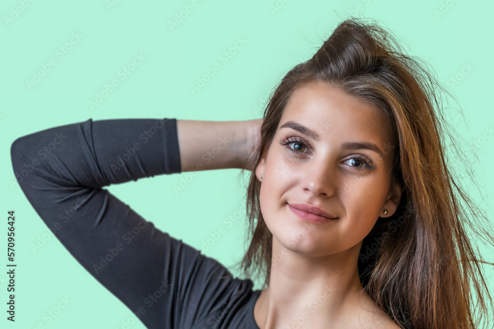 Portrait of smiling long haired beautiful girl on the green background. Horizontally. Portrait of smiling long haired beautiful girl on the green background. Horizontally.