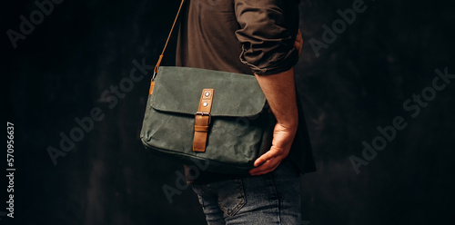 Man with duffle bag on shoulder. leather and canvas bag