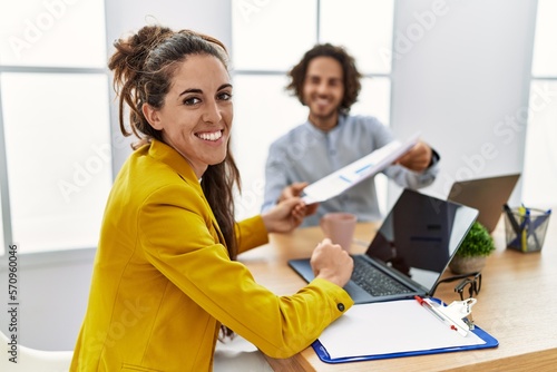 Man and woman business workers smiling confident working at office