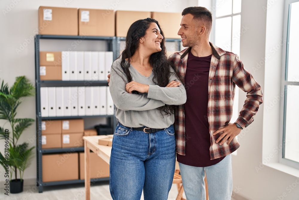 Man and woman ecommerce bussines workers standing together at office