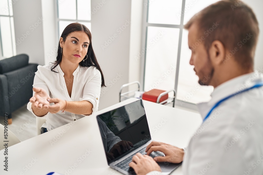 Man and woman doctor and patient having medical consultation at clinic Man and woman doctor and patient having medical consultation at clinic