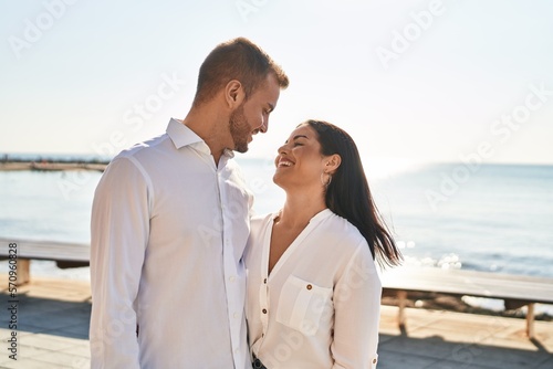 Man and woman couple smiling happy hugging each other standing at seaside © Krakenimages.com