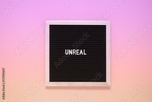 Papier peint Word unreal from letters on pink background