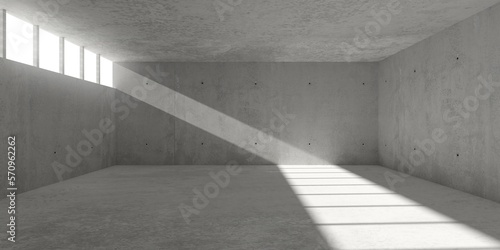 Abstract large, empty, modern concrete room with sunlight from wall opening with window grid and rough floor - industrial interior background template