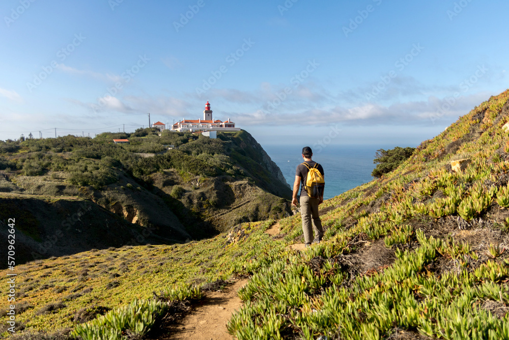 Man hiking near Cabo Da Roca lighthouse in Sintra Mountain Range in Portgual