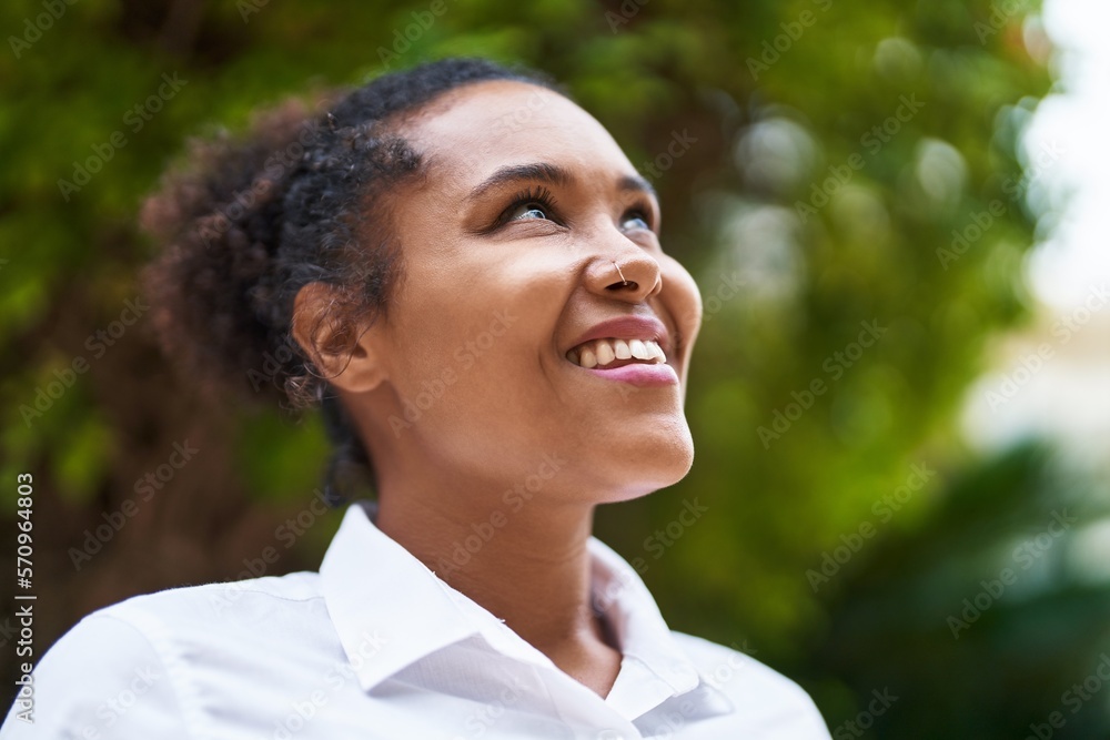 African american woman smiling confident looking to the sky at park African american woman smiling confident looking to the sky at park
