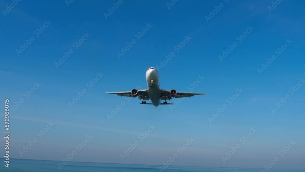 Jet plane descending to landing in the blue sky. Tourism and travel concept Jet plane descending to landing in the blue sky. Tourism and travel concept