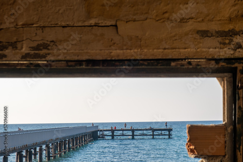 Pier through a rusted window photo