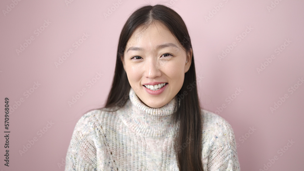 Young chinese woman smiling confident standing over isolated pink background Young chinese woman smiling confident standing over isolated pink background