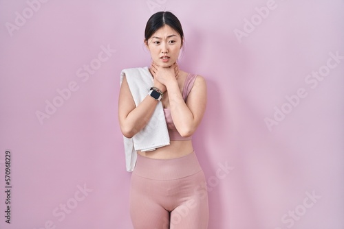 Chinese young woman wearing sportswear and towel shouting suffocate because painful strangle. health problem. asphyxiate and suicide concept.