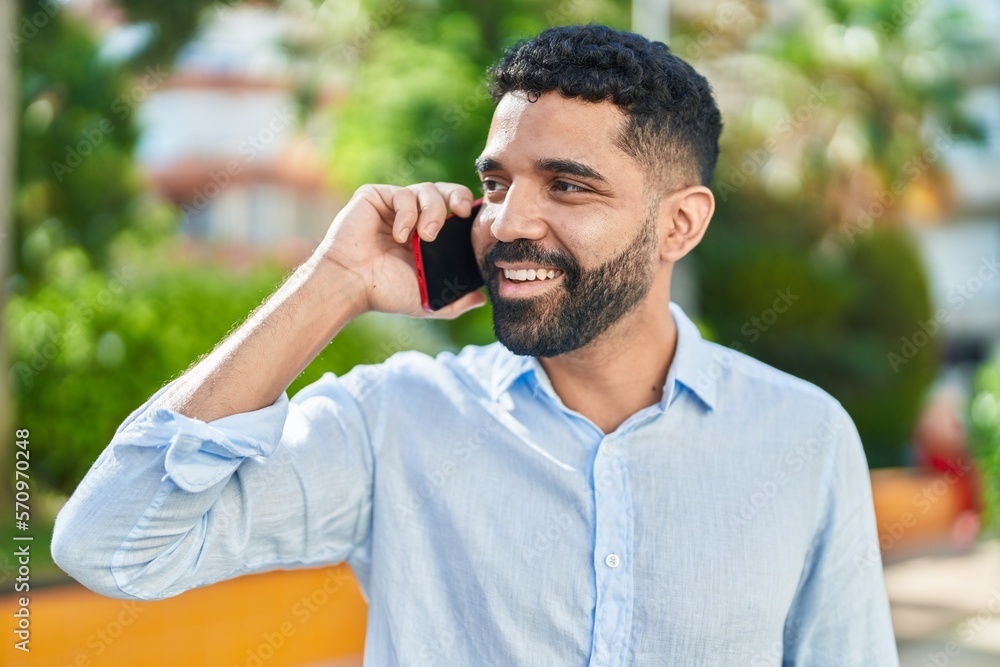 Young arab man smiling confident talking on the smartphone at park Young arab man smiling confident talking on the smartphone at park
