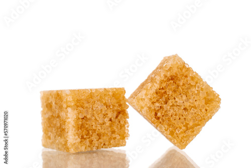 Two cubes of brown sugar, macro, isolated on white background.