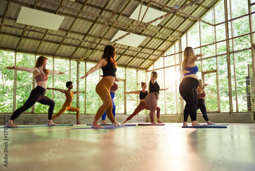 Group of people working out in gym. Yoga class group of women photo