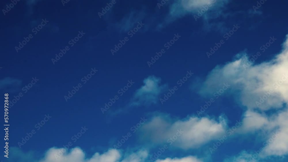 White fluffy cumulus clouds are flying, fast moving blue sky on a cloudy winter day. Blue sky white clouds. Cumulus cloud cloudscape timelapse. Fast moving white clouds and blue sky. White fluffy cumulus clouds are flying, fast moving blue sky on a cloudy winter day. Blue sky white clouds. Cumulus cloud cloudscape timelapse. Fast moving white clouds and blue sky.