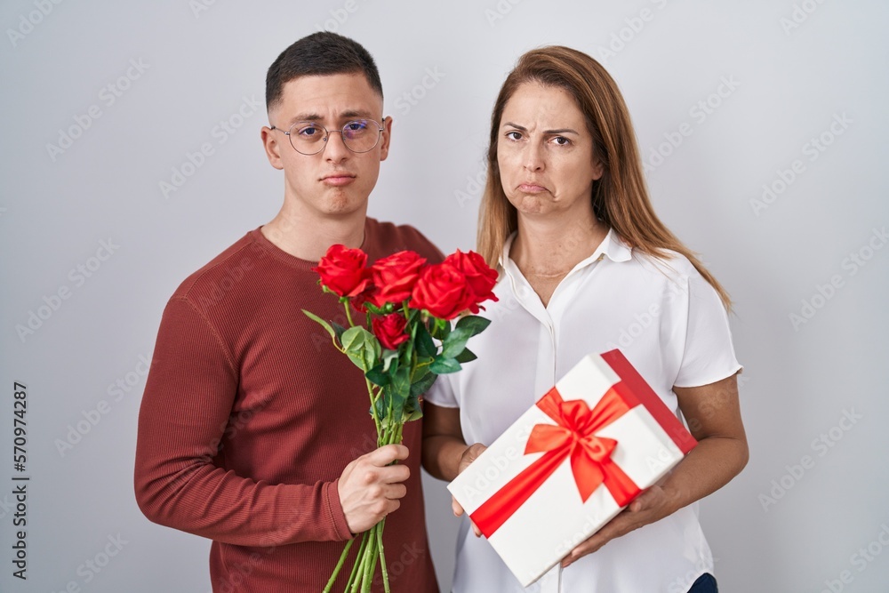 Mother and son holding mothers day gift depressed and worry for distress, crying angry and afraid. sad expression. Mother and son holding mothers day gift depressed and worry for distress, crying angry and afraid. sad expression.