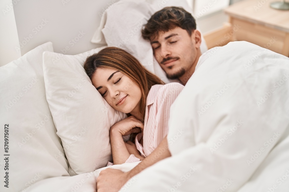 Mand and woman couple lying on bed sleeping at bedroom Mand and woman couple lying on bed sleeping at bedroom