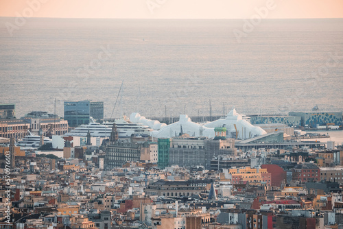 Aerial view of beautiful seascape and buildings at the Moll de Gregal del Port Olympic in Barcelona, Catalunya, Spain during sunset