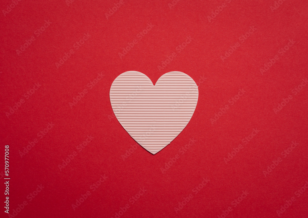 Paper heart on a red background