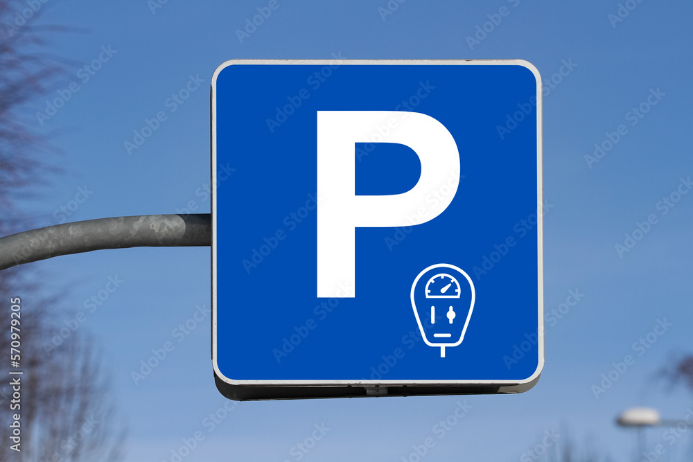 Close-up of the paid parking sign against blue sky Close-up of the paid parking sign against blue sky