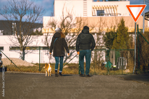 Couple walking a dog