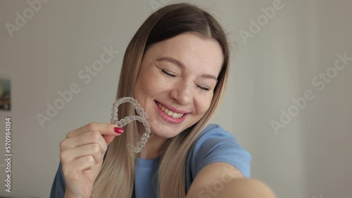 Woman Wearing Orthodontic Plastic Invisalign Brace. Mobile Orthodontic Appliance For Dental Correction. Tooth Whitening Systems. Woman Holding Invisalign Braces, Dental Healthcare And Orthodontic