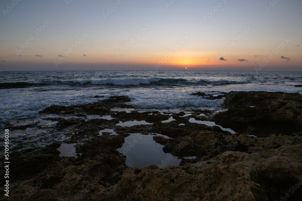 Rocky beach on the Mediterranean Sea at sunset
