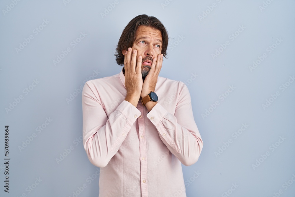 Handsome middle age man wearing elegant shirt background tired hands covering face, depression and sadness, upset and irritated for problem Handsome middle age man wearing elegant shirt background tired hands covering face, depression and sadness, upset and irritated for problem