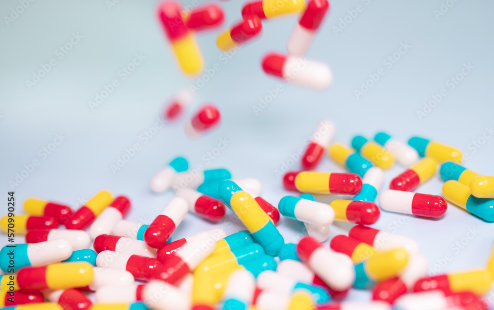 Creative layout of colorful pills and capsules on blue background. Minimal medical concept. Pharmaceutical, Medicine. Flat lay, top view. Creative layout of colorful pills and capsules on blue background. Minimal medical concept. Pharmaceutical, Medicine. Flat lay, top view.