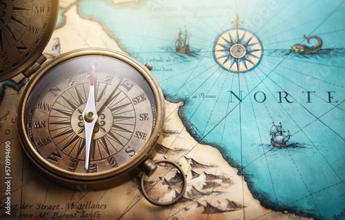 Magnetic old compass on world map.Travel, geography, navigation, tourism and exploration concept background. Treasure Island on the Pirate Map.