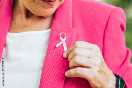 senior woman happy with pink ribbon  awareness