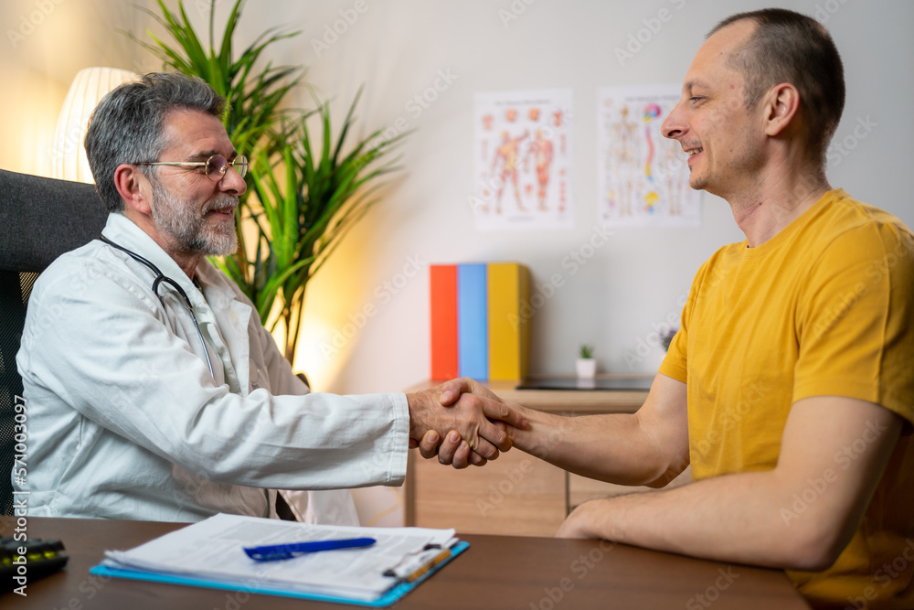 Medicine and health care concept, Professional Male doctor in white coat handshake with patient after successful recommend treatment methods Medicine and health care concept, Professional Male doctor in white coat handshake with patient after successful recommend treatment methods