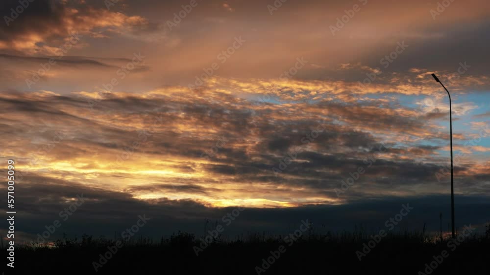 Trucks and cars driving along the highway at high speed. Sky bright red clouds Trucks and cars driving along the highway at high speed. Sky bright red clouds
