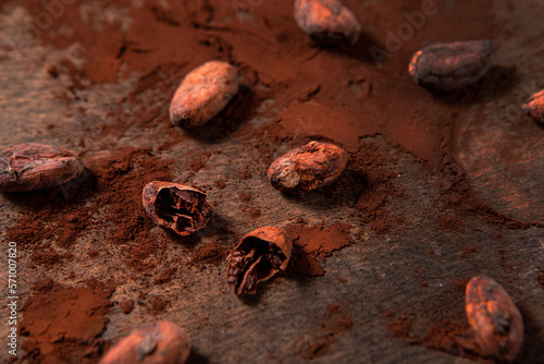Tasy cocoa powder, beans and dark chocolate in a wooden background photo