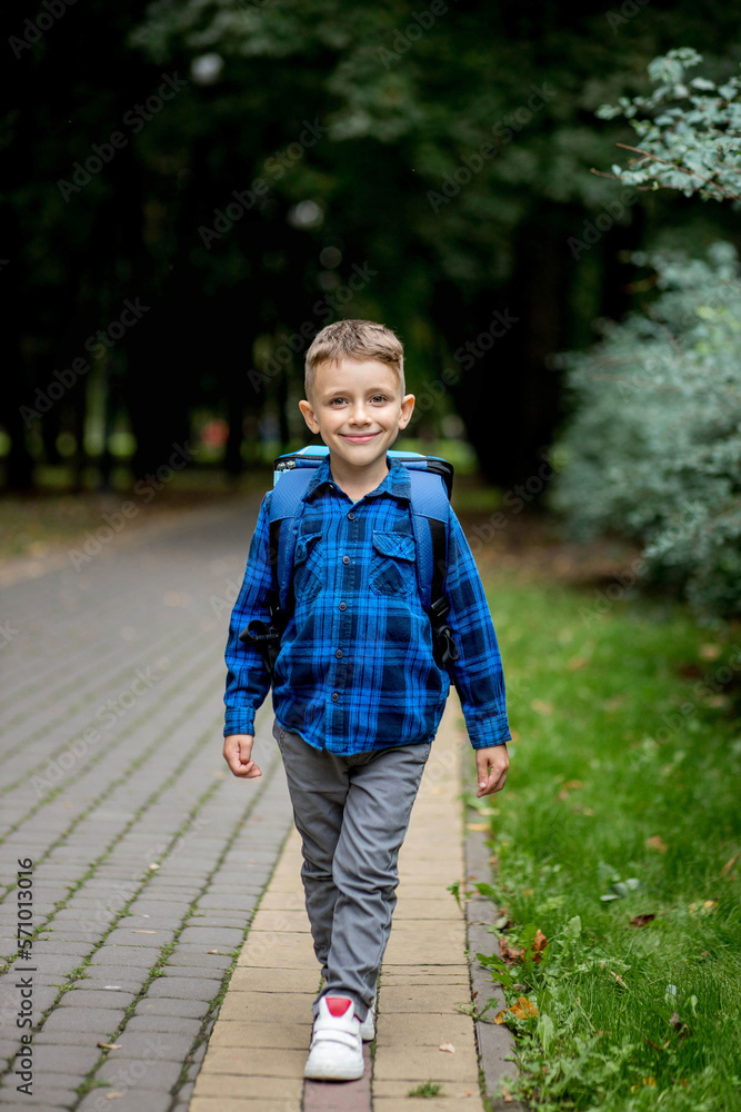 Portrait of a first grader with a backpack. The boy goes to school Portrait of a first grader with a backpack. The boy goes to school